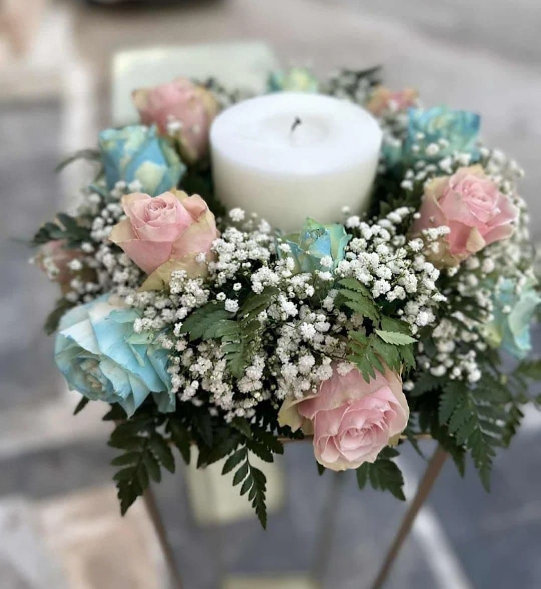 Baptism candle decoration with pink and white flower arrangements